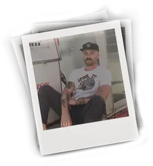 Image of man sitting by gas pump wearing a Kaspers Tee T-shirt